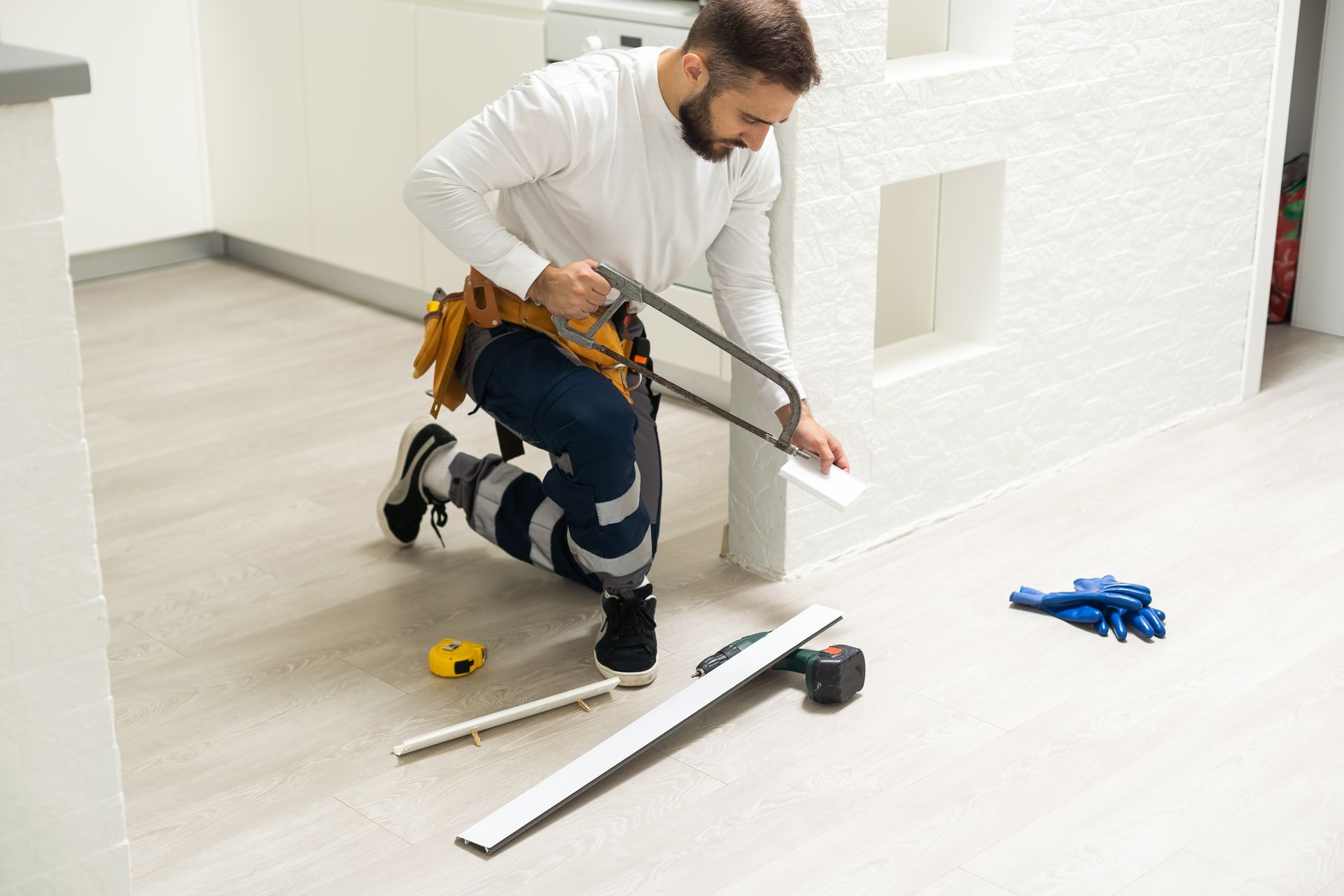 A man installing a skirting trim